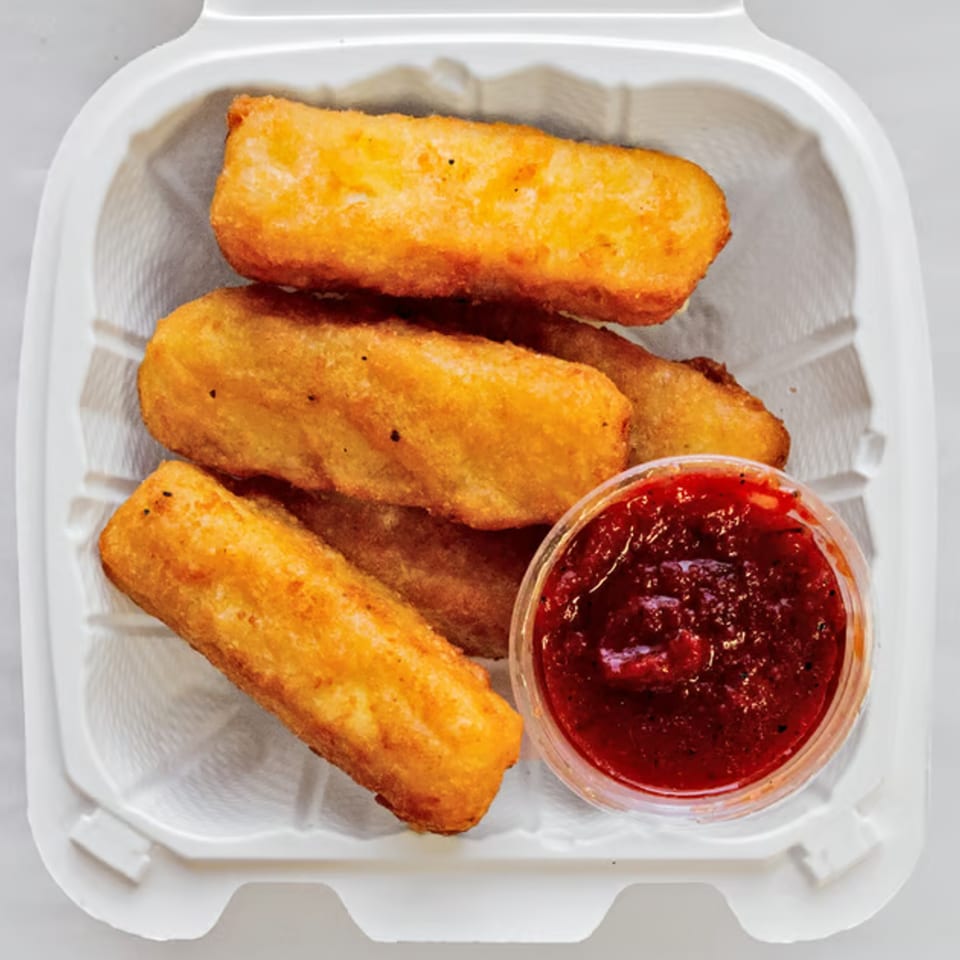Golden-brown fried mozzarella sticks and a cup of marinara sauce in a white takeout container.