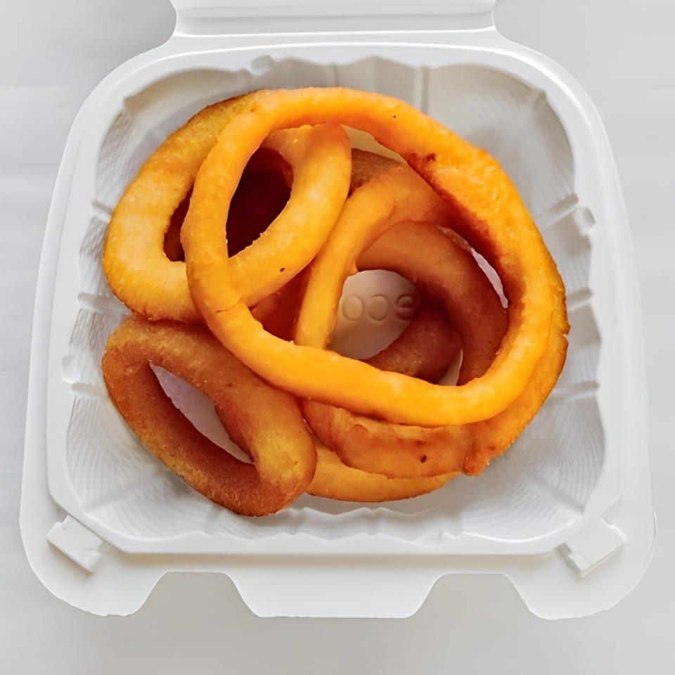Golden curly fries from Massey's Pizza & Chicken, served in a white takeout container.